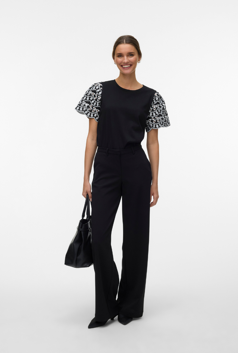 Front image of a model wearing Jasy o neck top in black, by brand Vero moda