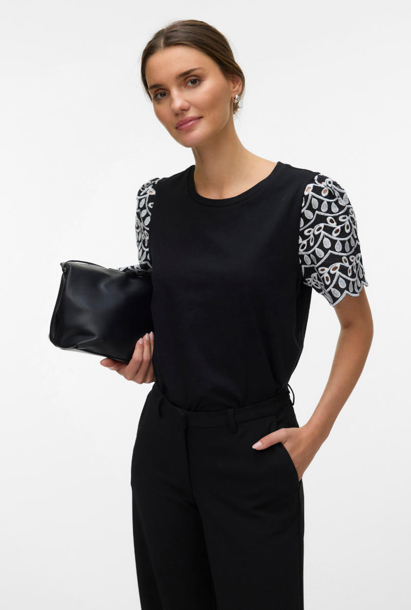 Front image of a model wearing Jasy o neck top in black, by brand Vero moda