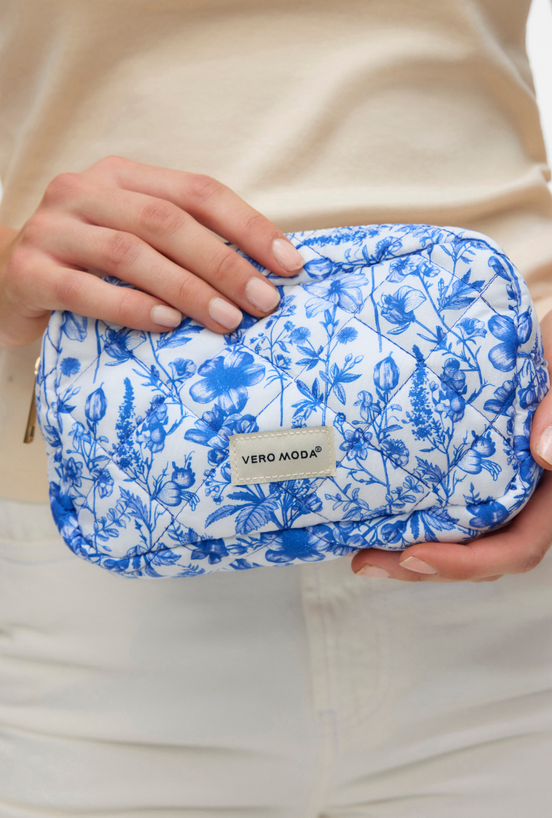 Front detail image of a model wearing Joy toilet bag in blue, by brand Vero moda