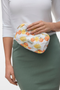 Front detail image of a model wearing Joy toilet bag in lemon, by brand Vero moda