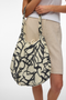 Front image of a model wearing Lina net bag in black/white, by brand Vero moda