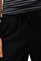 Front detail image of a model wearing the Milo ankle pants in black, by brand Vero moda