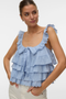 Front image of a model wearing the Sandy layered top in blue, by brand Vero moda