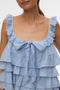 Front detail image of a model wearing the Sandy layered top in blue, by brand Vero moda