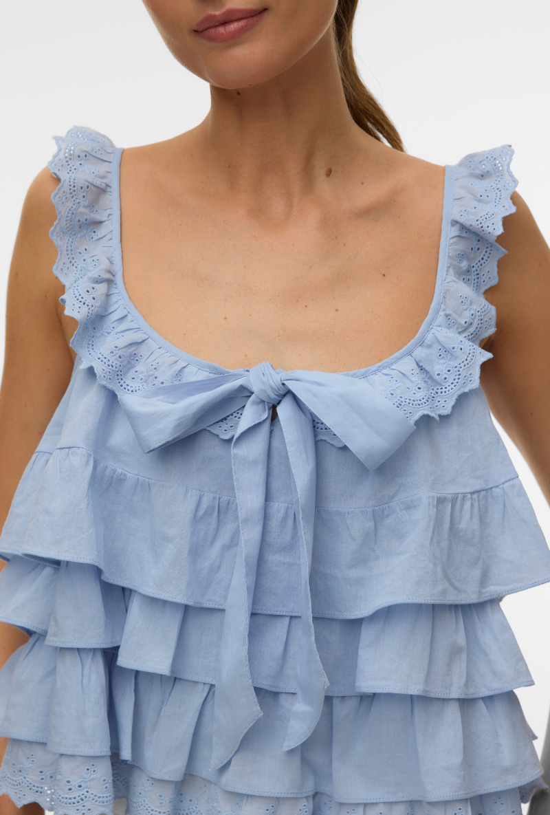Front detail image of a model wearing Sandy layered top in blue, by brand Vero moda