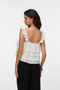 Back image of a model wearing the Sandy layered top in white, by brand Vero moda