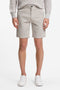 Front image of a model wearing Chino slim shorts in light grey, by brand Boss