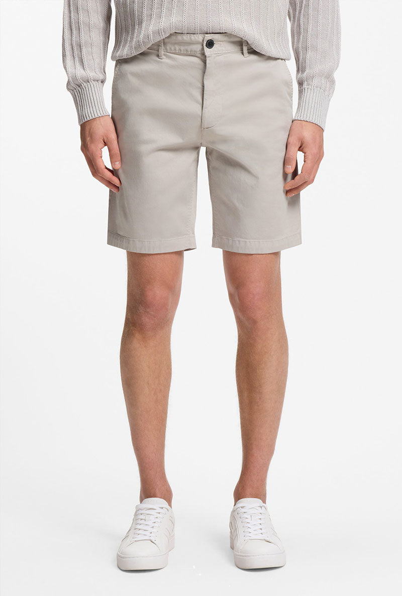 Front image of a model wearing Chino slim shorts in light grey, by brand Boss