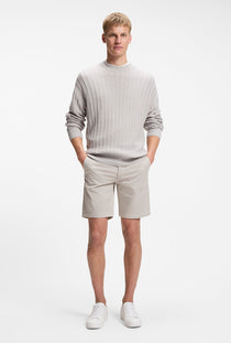 Front image of a model wearing the Chino slim shorts in light grey, by brand Boss