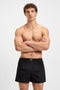 Front image of a model wearing the Cw peach 2 pk boxer shorts in black, by brand Boss