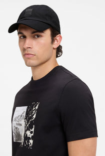 Front image of a model wearing the Derrel cap in black, by brand Boss