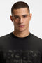 Front image of a model wearing the Globe logo tshirt in black, by brand Boss