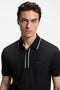 Front image of a model wearing the Philix zip polo in black, by brand Boss