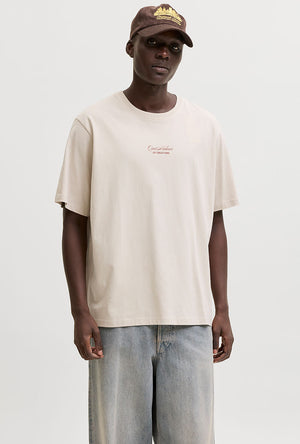 Front image of a model wearing the Art print tee in beige, by brand Jack&jones