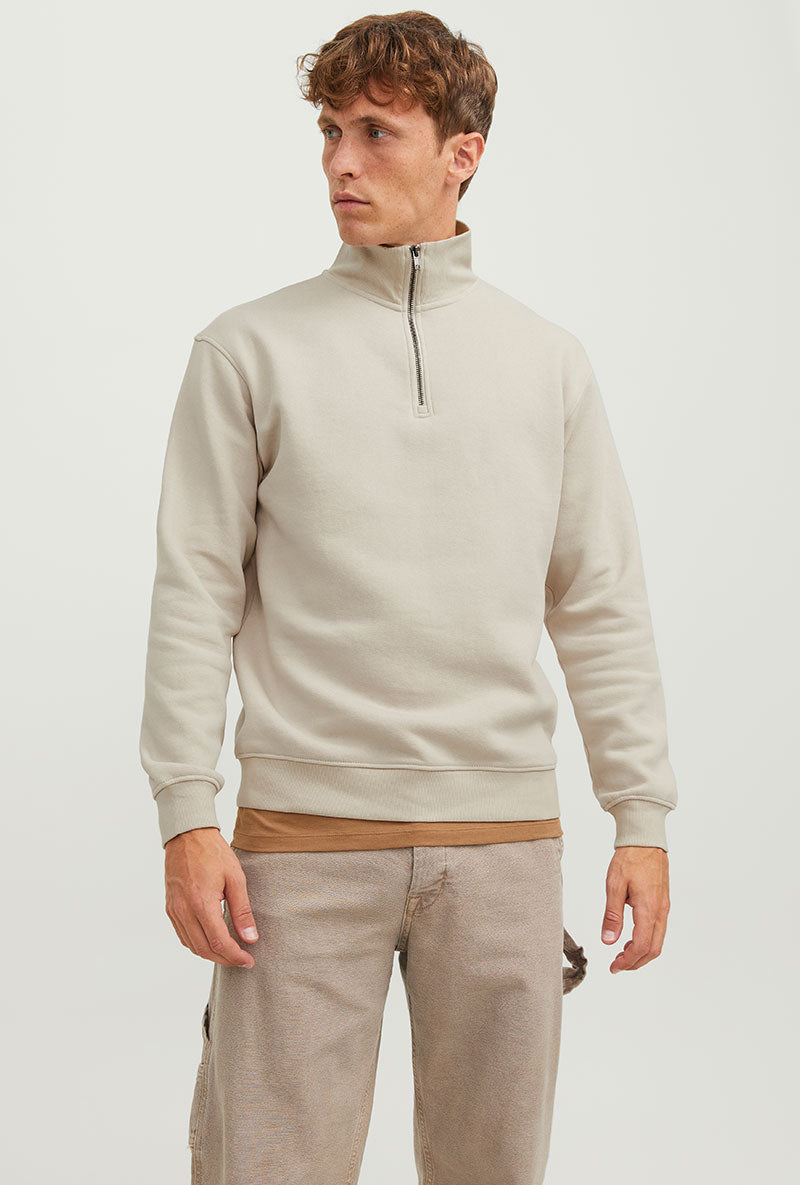 Front image of a model wearing Bradley sweat half zip sweatshirt in beige, by brand Jack&jones