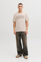 Front image of a model wearing Jack and jones jeff logo tee in stone, by brand Jack&jones