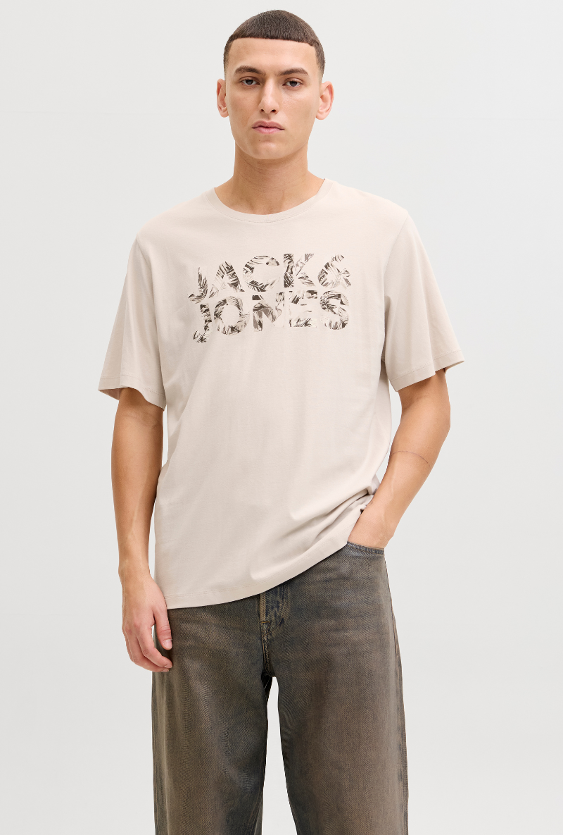 Front image of a model wearing Jack and jones jeff logo tee in stone, by brand Jack&jones