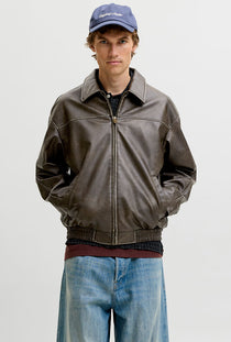 Front image of a model wearing the Marlon pu jacket in brown, by brand Jack&jones