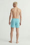 Back image of a model wearing the Maui vibrant wash swimshorts in blue, by brand Jack&jones