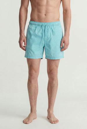 Front image of a model wearing the Maui vibrant wash swimshorts in blue, by brand Jack&jones