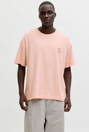 Front image of a model wearing Montauk back graphic tee in peach, by brand Jack&jones