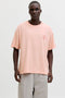 Front image of a model wearing Montauk back graphic tee in peach, by brand Jack&jones