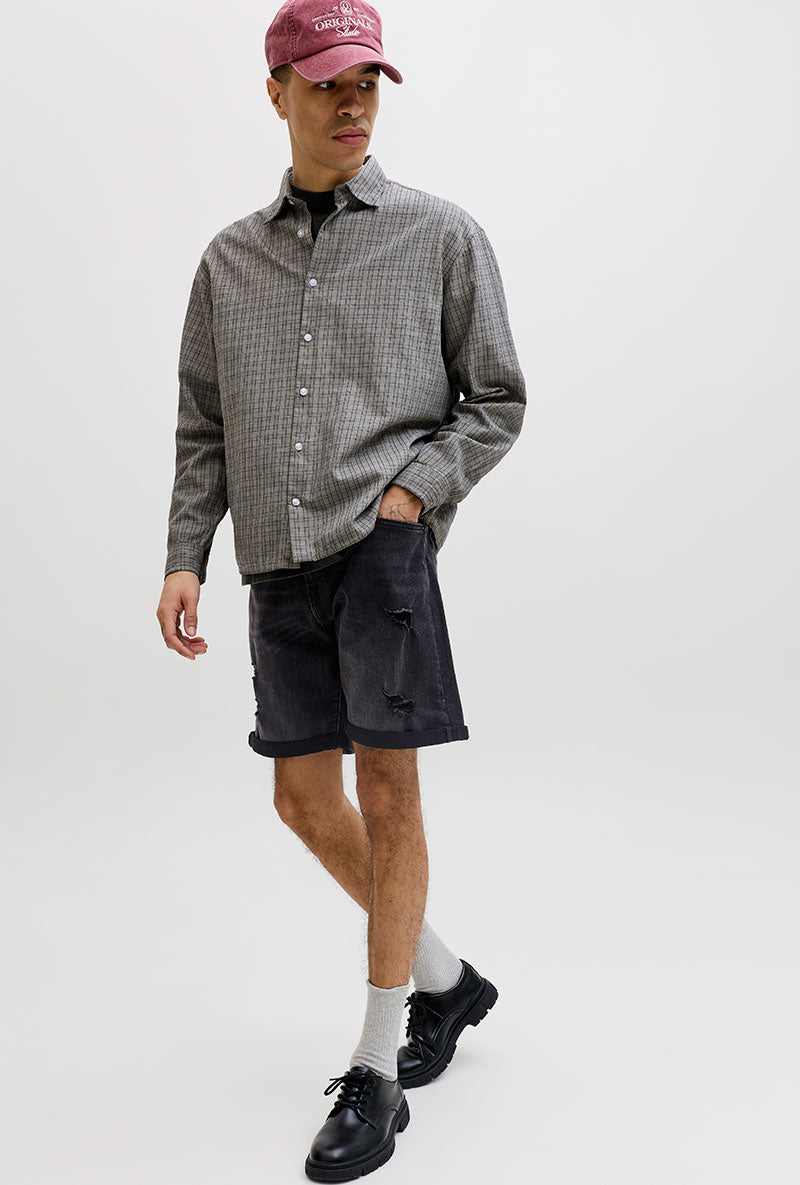 Front image of a model wearing Rick jj fox denim shorts in black, by brand Jack&jones