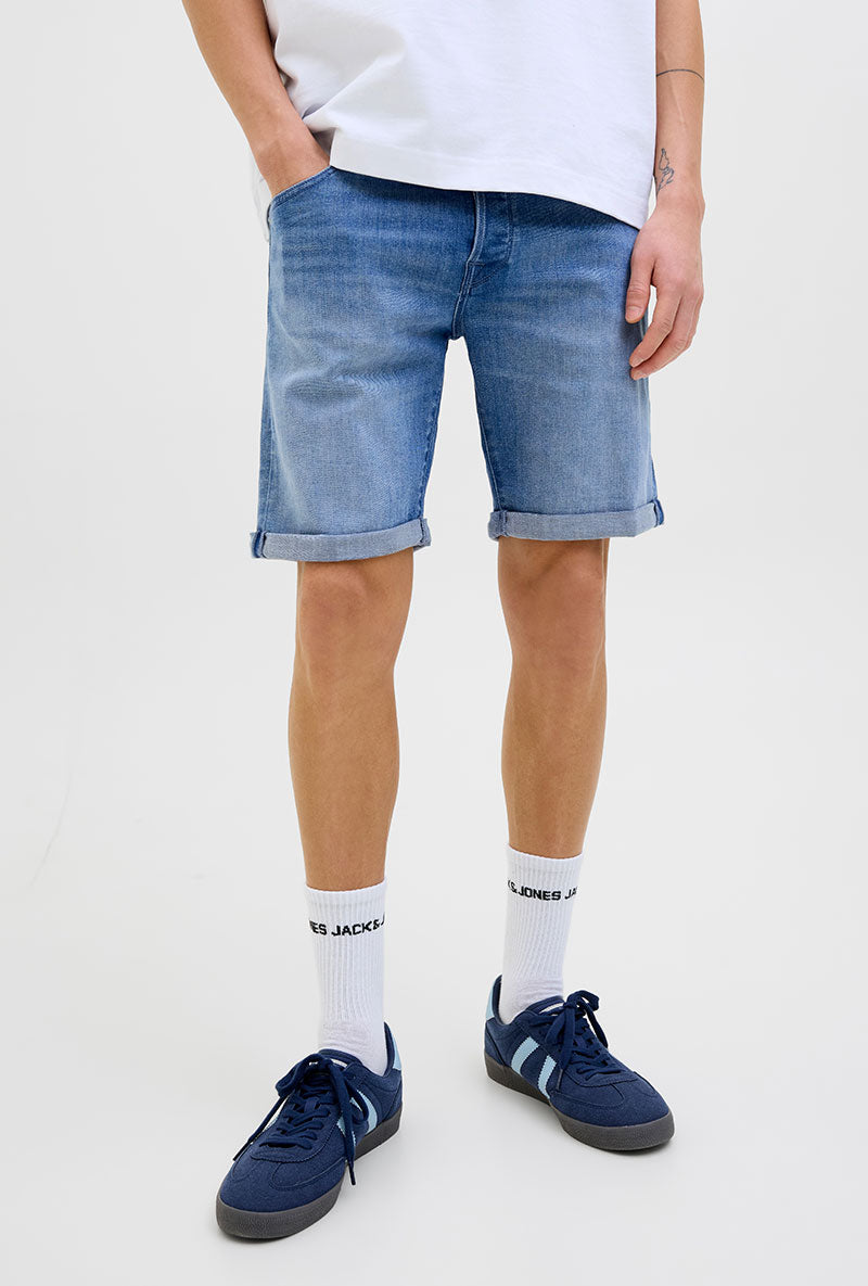 Front image of a model wearing Rick jj fox denim shorts in light denim, by brand Jack&jones