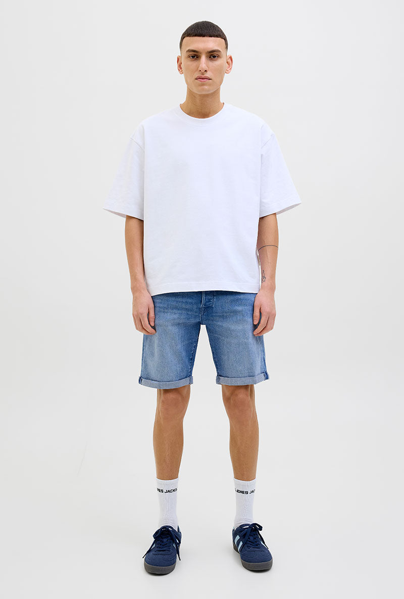 Front image of a model wearing Rick jj fox denim shorts in light denim, by brand Jack&jones