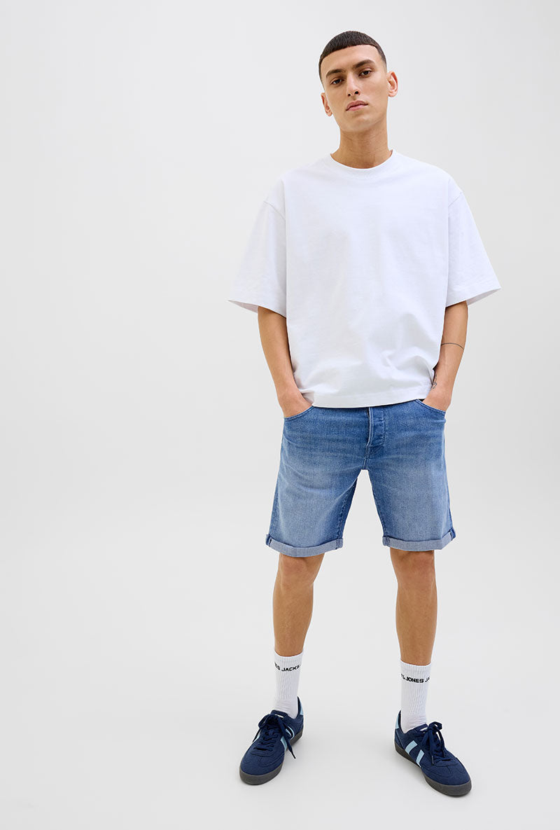 Front image of a model wearing Rick jj fox denim shorts in light denim, by brand Jack&jones