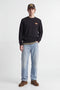 Front image of a model wearing the Rush sweat crew neck sweatshirt in black, by brand Jack&jones