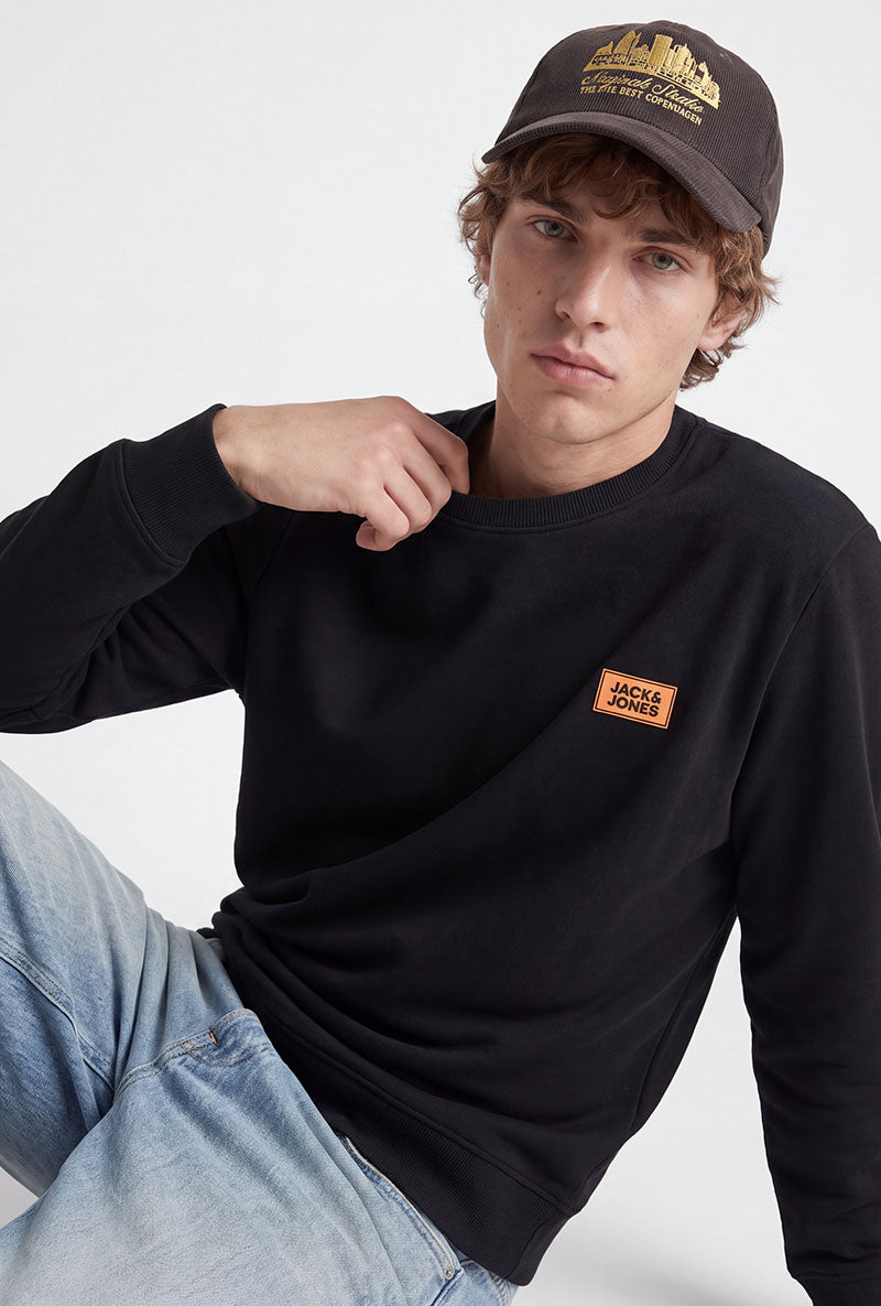 Front image of a model wearing Rush sweat crew neck sweatshirt in black, by brand Jack&jones