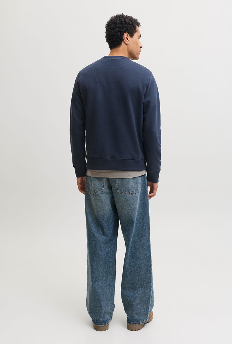 Back image of a model wearing Rush sweat crew neck sweatshirt in navy, by brand Jack&jones