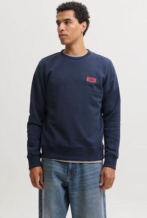 Front image of a model wearing Rush sweat crew neck sweatshirt in navy, by brand Jack&jones