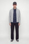 Front image of a model wearing the Soho ollie high neck zip knit in light grey, by brand Jack&jones
