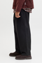 Side image of model wearing the Jack and jones stevan dylan jogger in black, by brand Jack&jones