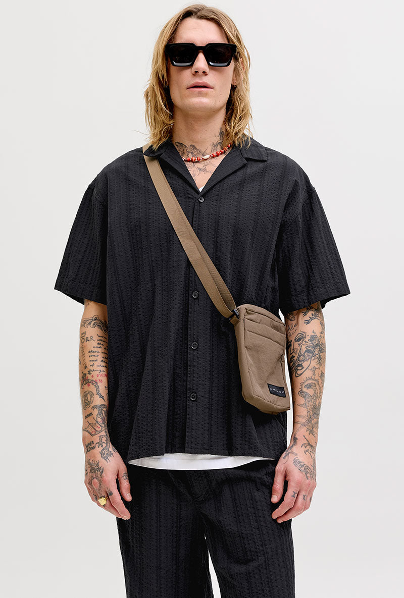 Front image of a model wearing Tyson resort shirt in black, by brand Jack&jones