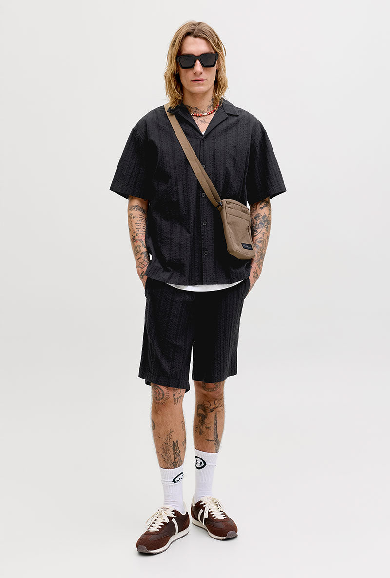 Front image of a model wearing Tyson resort shirt in black, by brand Jack&jones