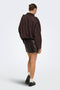 Back image of a model wearing the Ella pu mini skirt in black, by brand Jacqueline de yong