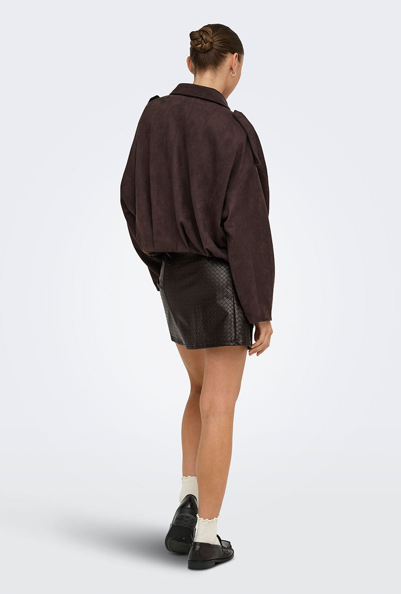 Back image of a model wearing Ella pu mini skirt in black, by brand Jacqueline de yong