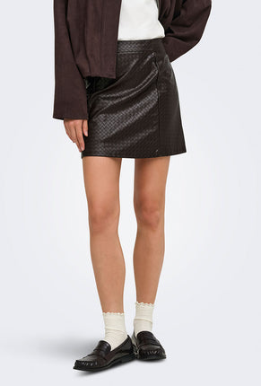 Front image of a model wearing Ella pu mini skirt in black, by brand Jacqueline de yong