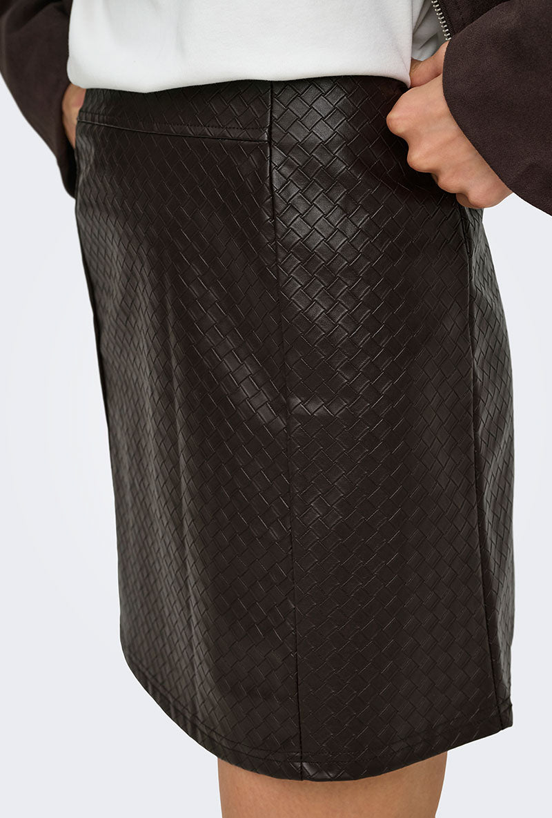 Front image of a model wearing Ella pu mini skirt in black, by brand Jacqueline de yong