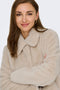 Front image of a model wearing the Macy faux fur jacket in beige, by brand Jacqueline de yong