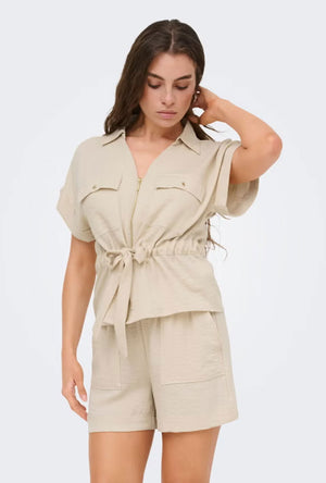 Front image of a model wearing the Mille ss zip shirt in beige, by brand Jacqueline de yong