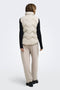 Back image of a model wearing the Power short waistcoat in beige, by brand Jacqueline de yong