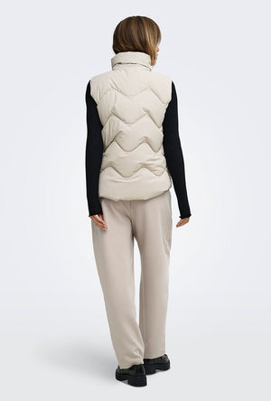 Back image of a model wearing the Power short waistcoat in beige, by brand Jacqueline de yong