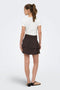 Back image of a model wearing the Theis life hw smock skirt in brown, by brand Jacqueline de yong