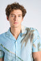 Front image of a model wearing the Aop summer viscose shirt in sky, by brand Lindbergh