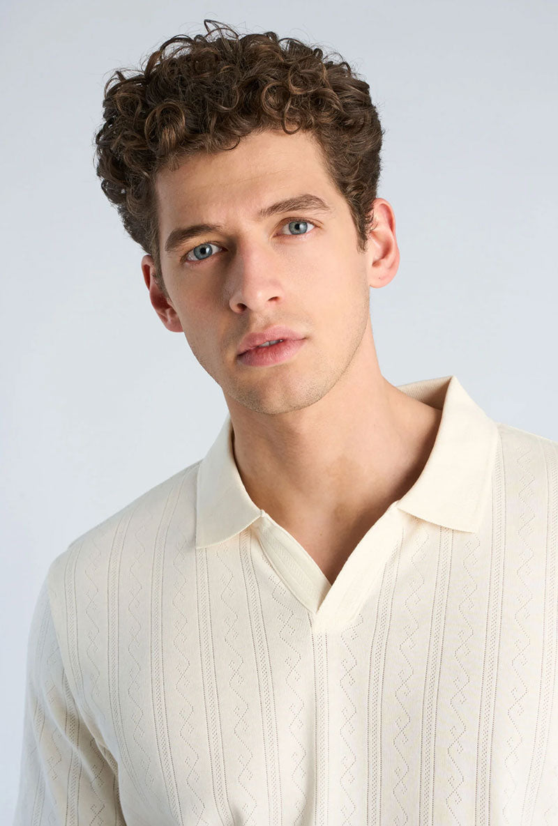 Front image of a model wearing Jacquard vneck polo in off white, by brand Lindbergh