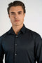 Front image of a model wearing the Plain sateen superlflex shirt in black, by brand Lindbergh
